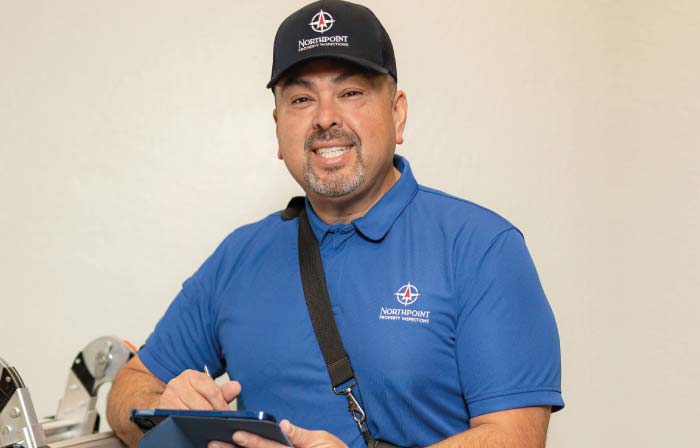 ASHI Certified Property Inspector Oscar Fregoso smiling in professional Northpoint gear, equipped with a tool belt and tablet, ready to provide a thorough residential home inspection in Northern California.